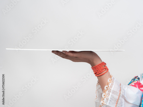 detail of hands of hispanic girl holding a plate with her hands, ready to add digitally any object photo