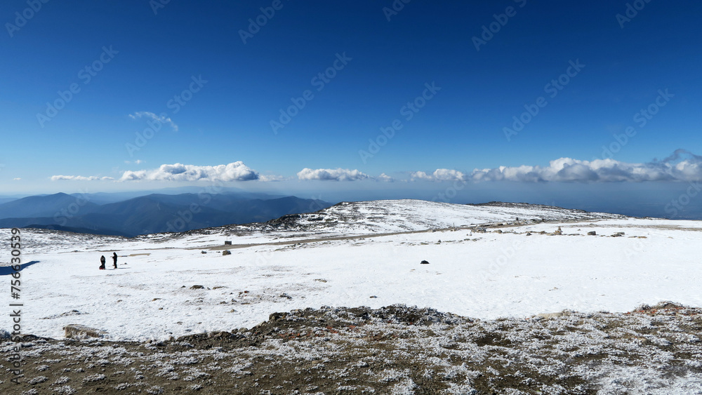 Serra da Estrela Natural Park (Portugal) covered in snow with silhouettes of people in the background