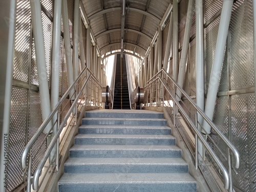 a city subway station crossing stairs, metal stairs, indoor with Stairs, stair way at shopping mall in city with guardrail, vertical shot of an new carpeted staircase