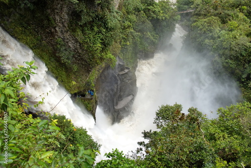 Mist rising off the pool at the base of the Pailon del Diablo waterfall, and around a stone viewing platform near the pool, in Banos, Ecuador