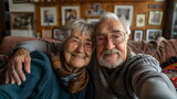 Act as a photographer capturing the joyful moment of a happy, smiling senior couple taking a selfie at their cozy home