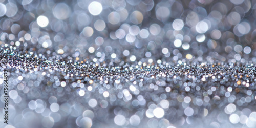 An abstract silver glitter background with soft bokeh