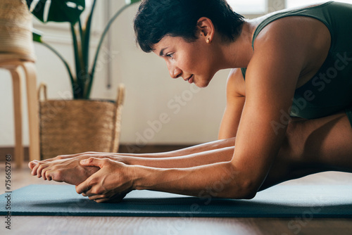 Beautiful sporty girl making yoga training photo