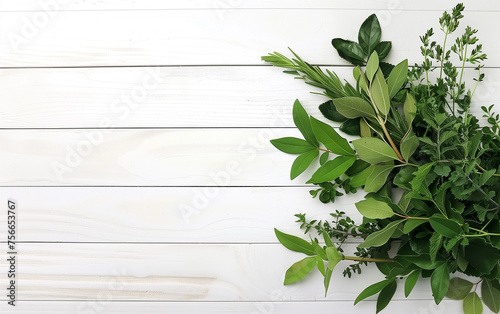 Bouquet of herbs composed of bay leaf, thyme and parsley, on a wooden white table. Fresh bouquet garni on wooden white table photo