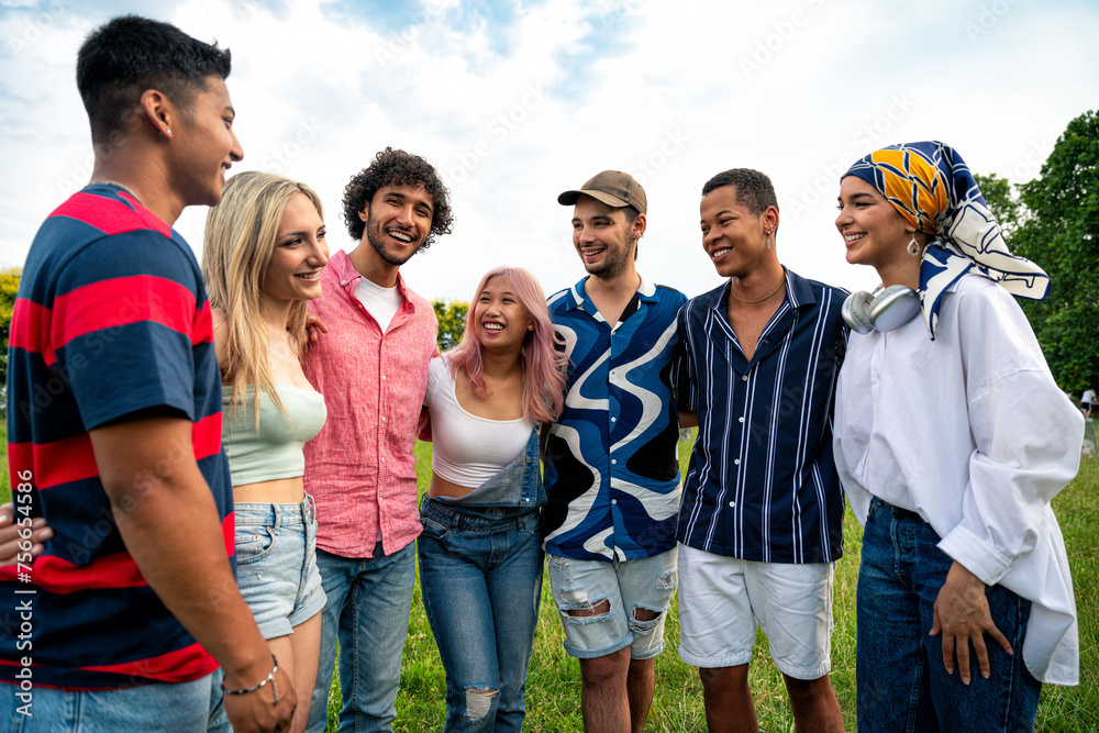 Group of multiethnic teenagers spending time outdoor on a picnic at the park Group of multiethnic teenagers spending time outdoor on a picnic at the park