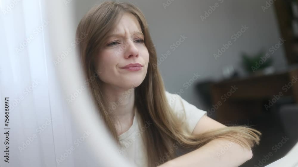 Portrait of sad young caucasian woman touching facial skin dissatisfied quality of care products while looking at mirror reflection at home Bad negative skin care treatment beauty concept Portrait of sad young caucasian woman touching facial skin dissatisfied quality of care products while looking at mirror reflection at home Bad negative skin care treatment beauty concept
