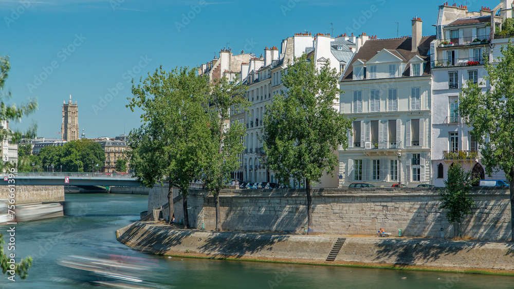 Saint-Louis bridge timelapse with houses on Orleans waterfront. Paris, France.