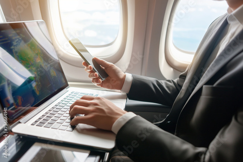 businessman working on laptop in a private plane