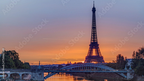 Eiffel Tower sunrise timelapse with boats on Seine river and in Paris, France.