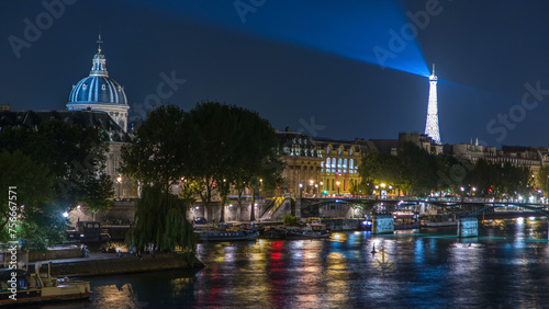 River Seine with Pont des Arts and Institut de France at night timelapse in Paris, France. photo