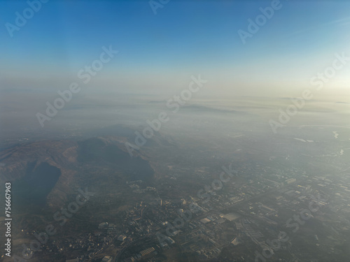 A city is seen from above with a hazy atmosphere