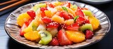 A closeup of a colorful fruit salad served on a table, showcasing a variety of fresh fruits like strawberries and other natural ingredients