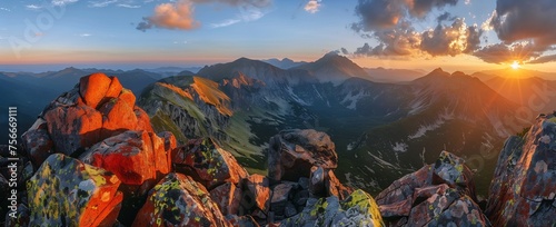panoramic view of the Tatra Mountains at sunrise, in late summer, on top of the Morfa mountain, golden light, red rocks, rocks with green moss