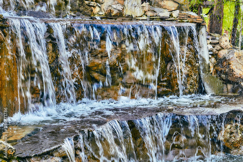 Pure mineral clean water flows over stepped mountain stones