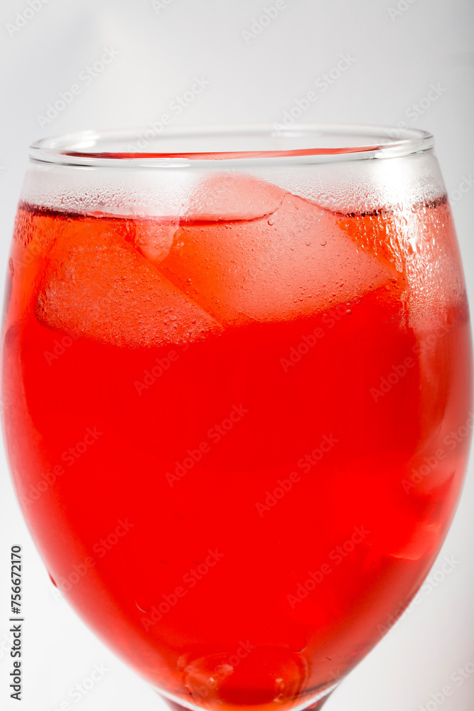 Red colored drink in a glass with ice macro photography as per likes of Rooh Afza and Jam e Shirin