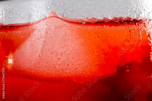 Red colored drink in a glass with ice macro photography as per likes of Rooh Afza and Jam e Shirin
