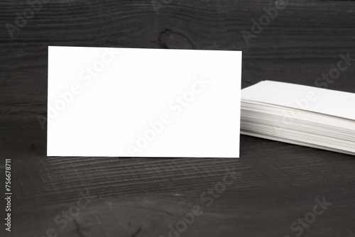 Blank business cards on the wooden table. Template for ID. Top view.