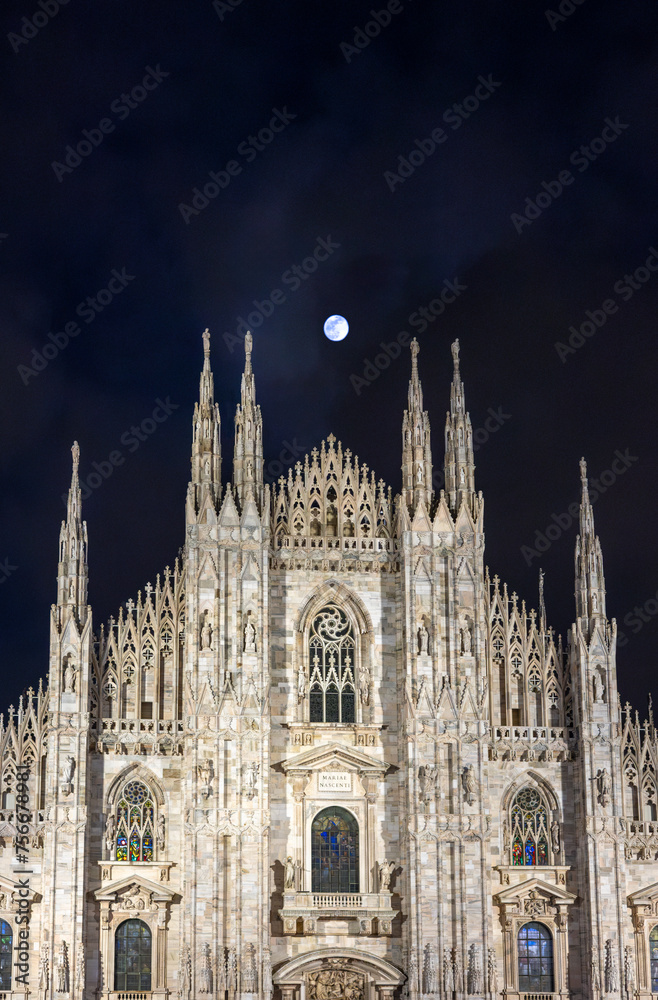 The famous Milan Cathedral (Duomo di Milano) on the Piazza del Duomo in Milan, Italy. Night and full moon