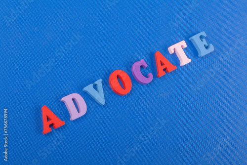 ADVOCATE word on blue background composed from colorful abc alphabet block wooden letters, copy space for ad text. Learning english concept.