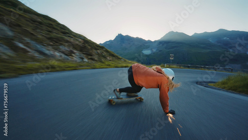 woman skateboarding and making tricks between the curves on a mountain pass. photo