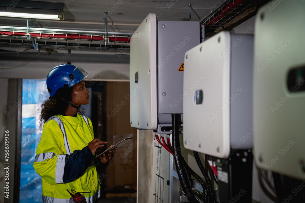 Engineers inspected the electrical switchboard and verified the operational voltage range. Technician setting electrical in inverter solar panel room Engineers inspected the electrical switchboard and verified the operational voltage range. Technician setting electrical in inverter solar panel room