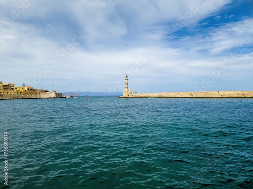 Lighthouse at Venetian harbour in Old Town of Chania. Wavy sea, city building. Crete island, Greece. © Rawf8