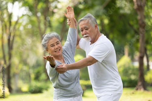 senior couple stretching before exercise and doing yoga in the park