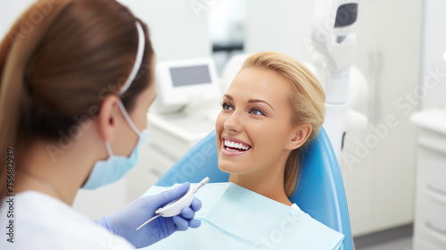 Patient with a bright smile sitting in a dental chair, looking up at a dentist who is examining him