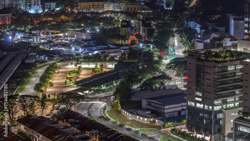 Aerial view to busy bus terminal in Singapore night timelapse. © neiezhmakov