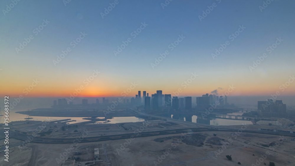 Abu Dhabi city skyline with skyscrapers at sunrise from above timelapse