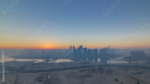 Abu Dhabi city skyline with skyscrapers at sunrise from above timelapse © neiezhmakov