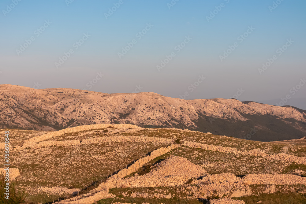 Panoramic view of dry stone walls mrgari on moon plateau seen from mountain top Hlam in Baska, Krk Island, Primorje-Gorski Kotar, Croatia, Europe. Hiking trail on barren deserted dry terrain. Ruins