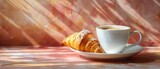 A delicious croissant with coffee.