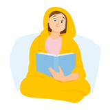 Young woman wrapped in a blanket reading a book