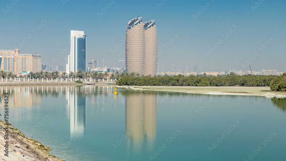 View of skyscrapers skyline with Al Bahr towers in Abu Dhabi timelapse. United Arab Emirates