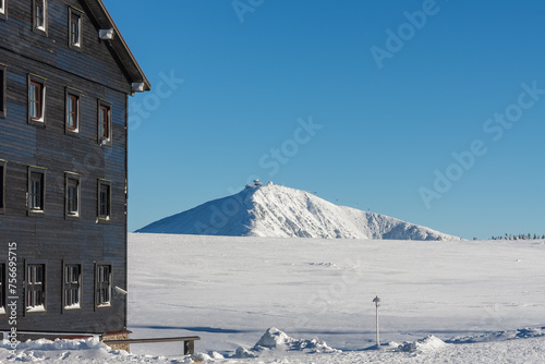 Meadow Hut, krkonose mountains Czech Republic. Winter morning, on background Snezka, mountain on the border between Czech Republic and Poland.