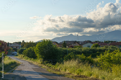 Rural Road With Houses and Mountains