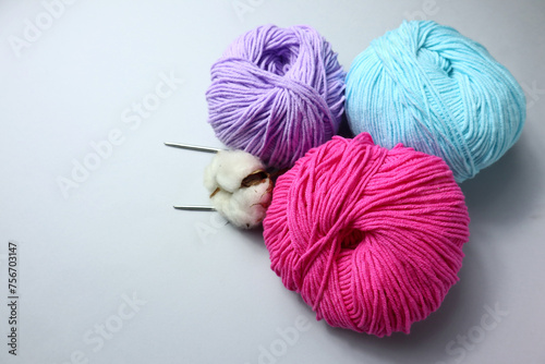 Colorful yarn balls on light background 