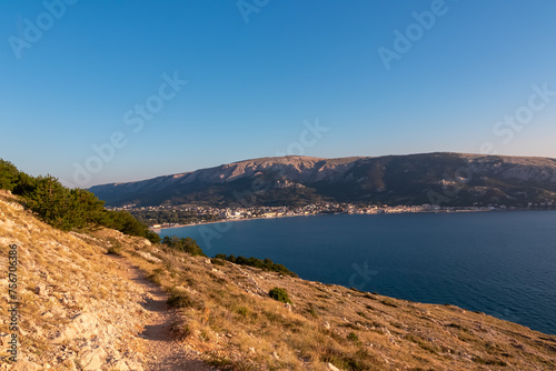 Scenic sunrise view of majestic coastline of Mediterranean Adriatic Sea in coastal town Baska, Krk Island, Primorje-Gorski Kotar, Croatia, Europe. Aerial vistas from idyllic hiking trail in summer © Chris