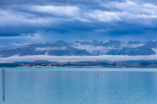 Photograph of Lake Tekapo in the early morning with snow-capped mountains in the background on the South Island of New Zealand