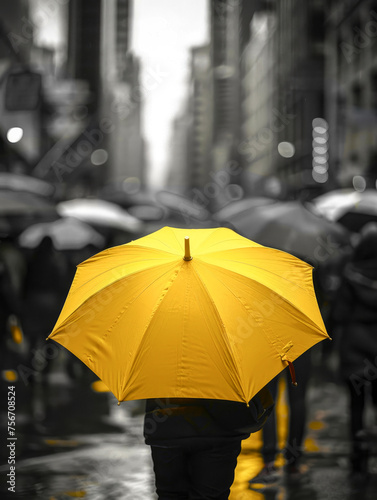 Gray gloomy dark day  rainy weather  everything is black and depressing  the only bright spot is a yellow umbrella  a color in the darkness.