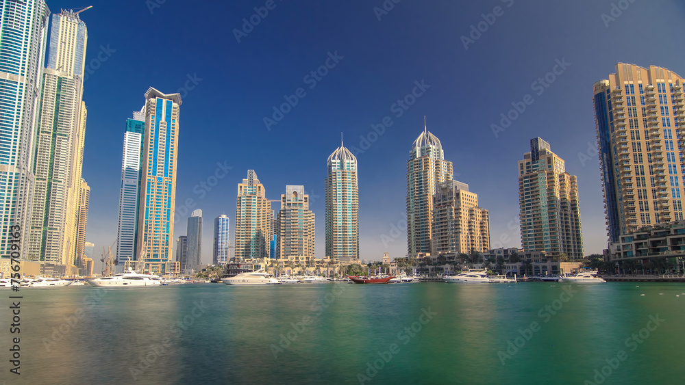 Obraz premium Dubai Marina with tallest skyscrapers and boats timelapse hyperlapse