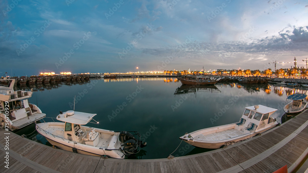 Fototapeta premium Fishing boat parked near the fish market next to Kuwait City Area day to night timelapse