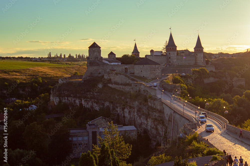 Kamianets-Podilskyi Castle during the sunset. It is a former Ruthenian-Lithuanian ancient defensive fortress located on a rock in the historic city of Kamianets-Podilskyi, Ukraine