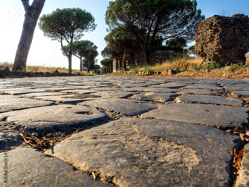 Photography The ancient Roman road called the Appian Way, taken at ground level with the stones forming its pavement in the very foreground