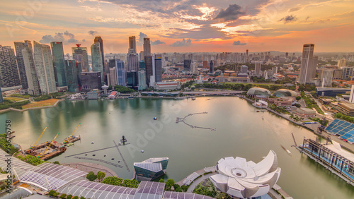 Panorama of Singapore Marina Bay with Financial District skyscrapers at sunset light reflected on the harbor timelapse.
