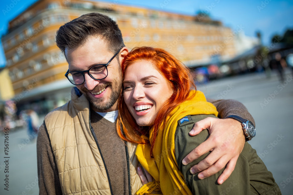 Smiling couple enjoying on vacation, young tourist having fun walking and exploring city street during the day. Smiling couple enjoying on vacation, young tourist having fun walking and exploring city street during the day.