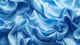 Abstract blue wavy crumpled shiny satin silk fabric textured textile background