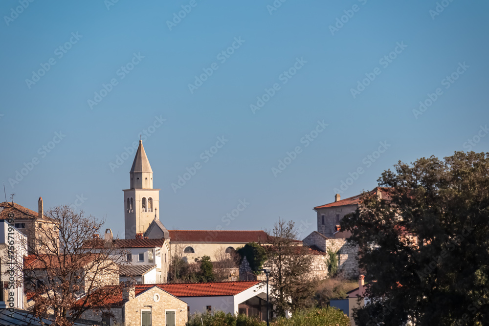 Scenic view of parish church of Saint Bernard in city centre of coastal town Funtana, Istria, Croatia. Adriatic Mediterranean architecture. Travel destination concept in summer. Tourism. Blue sky Scenic view of parish church of Saint Bernard in city centre of coastal town Funtana, Istria, Croatia. Adriatic Mediterranean architecture. Travel destination concept in summer. Tourism. Blue sky