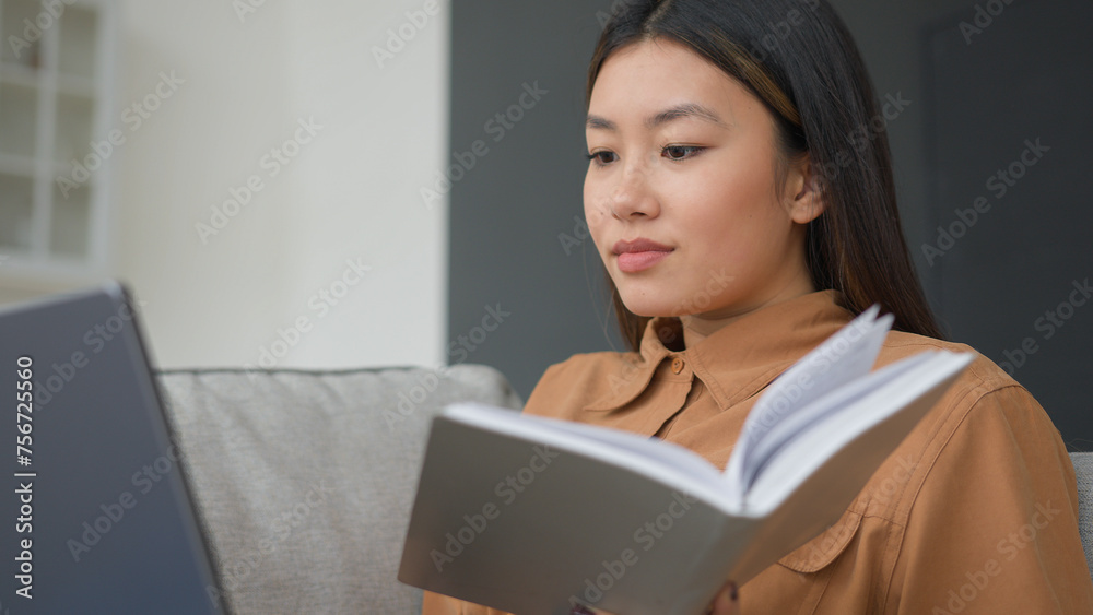 Asian woman businesswoman use laptop on sofa learning knowledge distance education at home write business plan writing notes in schedule notebook female korean student watch lesson online do homework Asian woman businesswoman use laptop on sofa learning knowledge distance education at home write business plan writing notes in schedule notebook female korean student watch lesson online do homework
